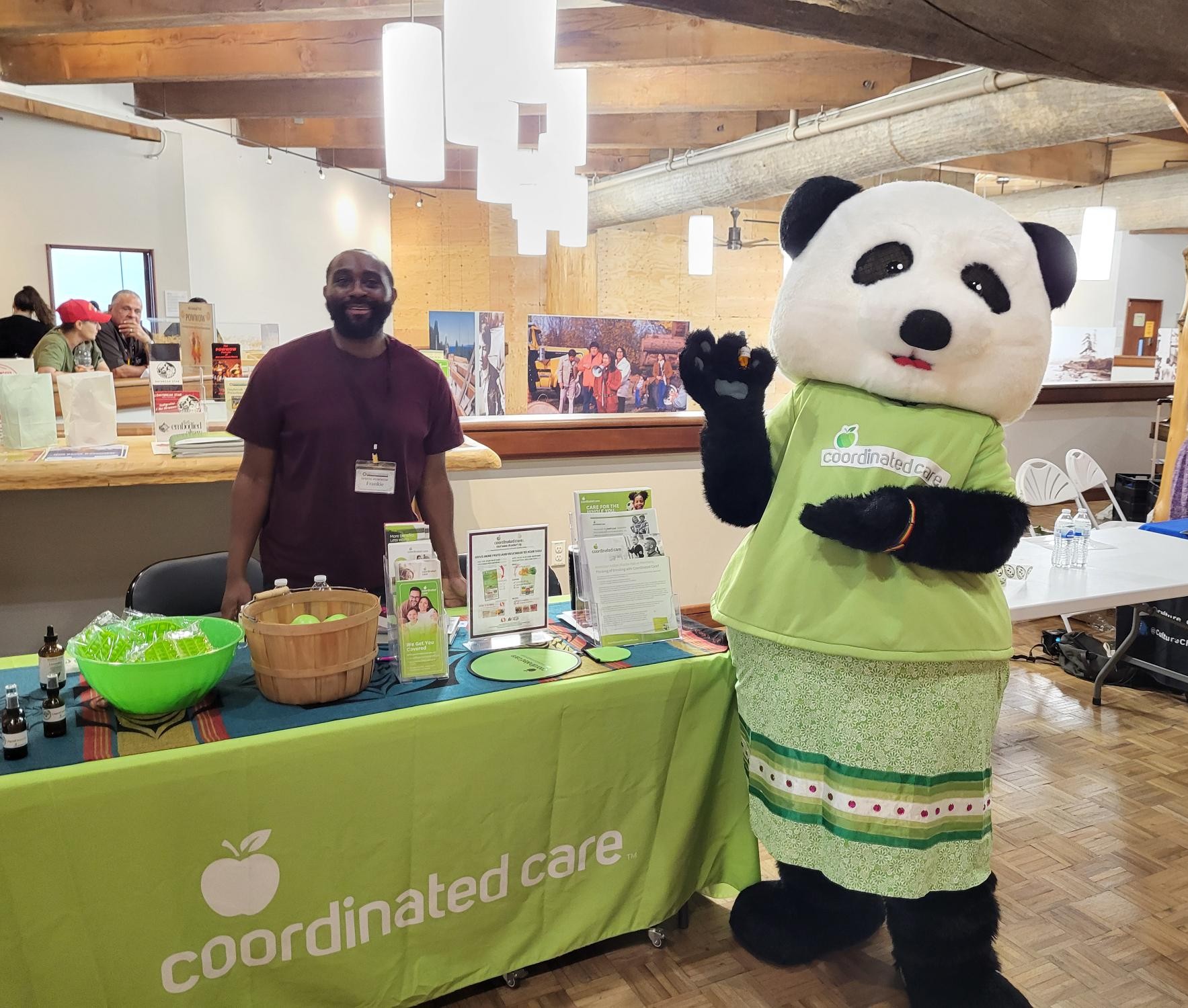 Coordinated Care's mascot at Powwow with staff member